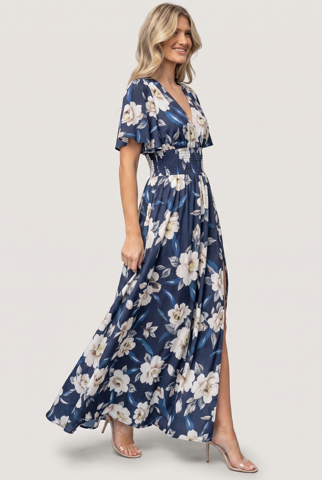 Verona Smocked Maxi Dress in navy and white floral, side view showing skirt drape and front slit