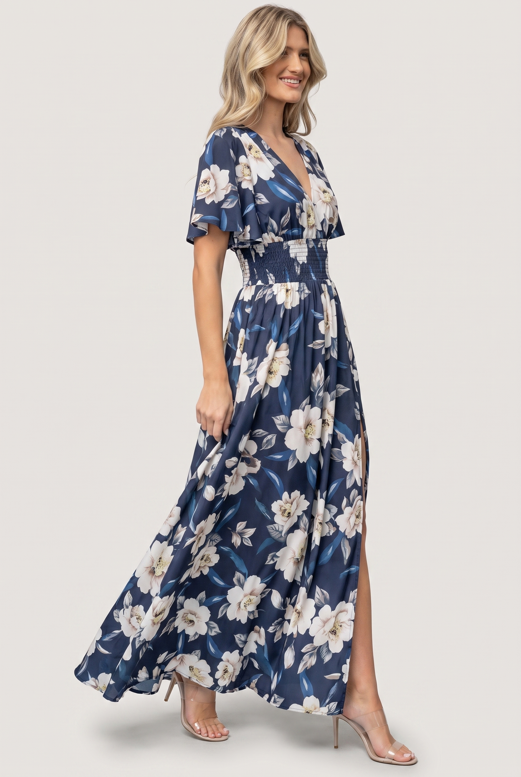 Verona Smocked Maxi Dress in navy and white floral, side view showing skirt drape and front slit