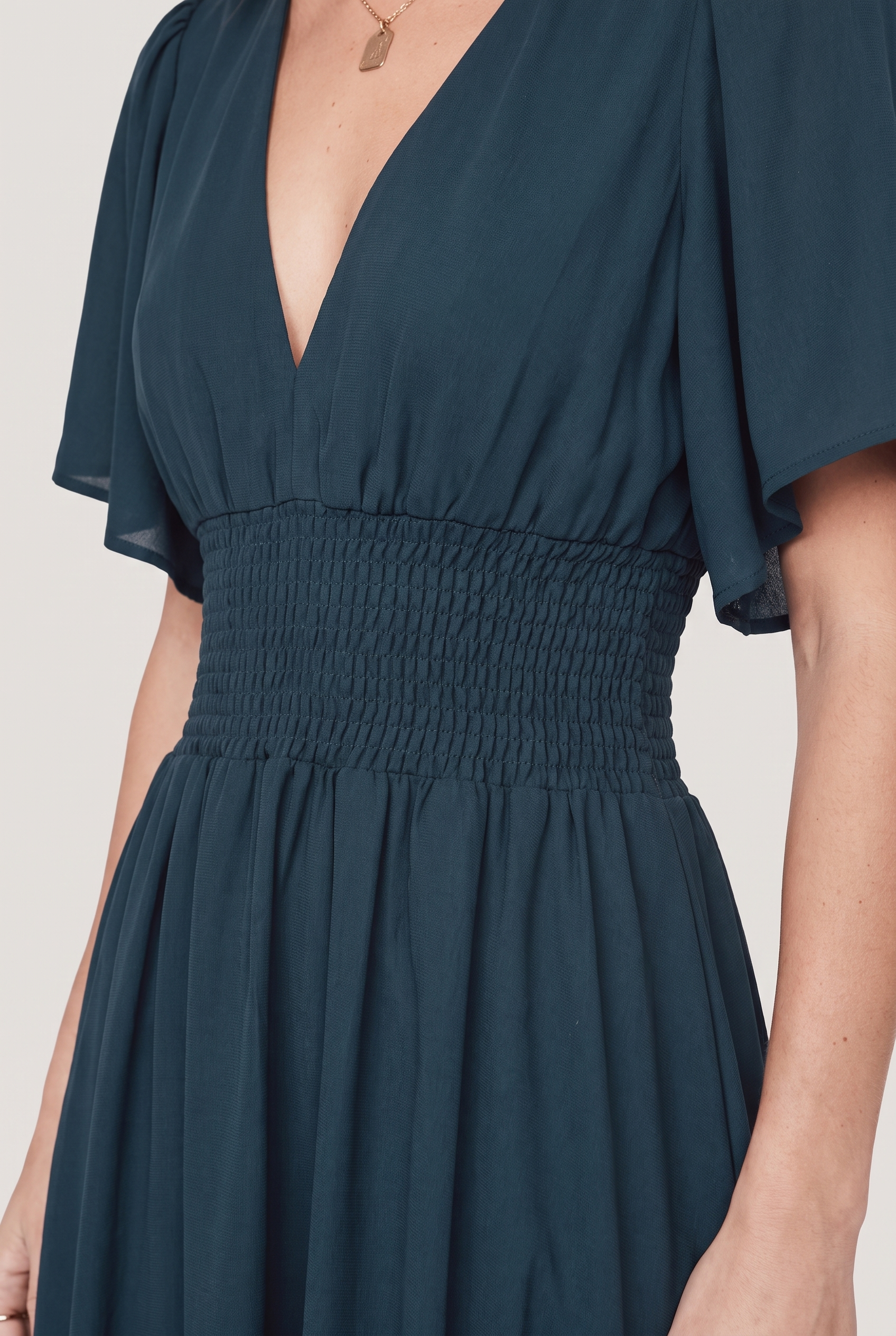 Verona Smocked Maxi Dress in Topaz teal, close-up of smocked waist and V-neckline